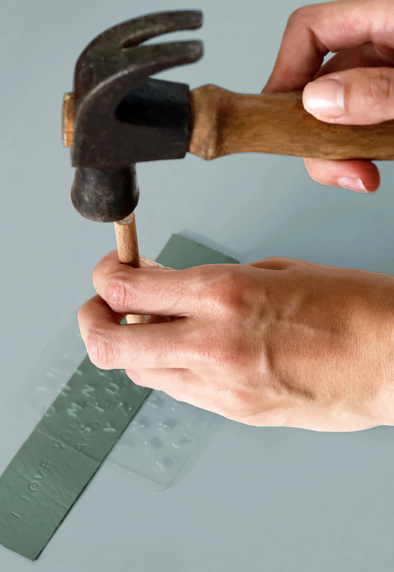 personalised bookmarks kit being used with stamping tools on bookmark blank and hammer in progress