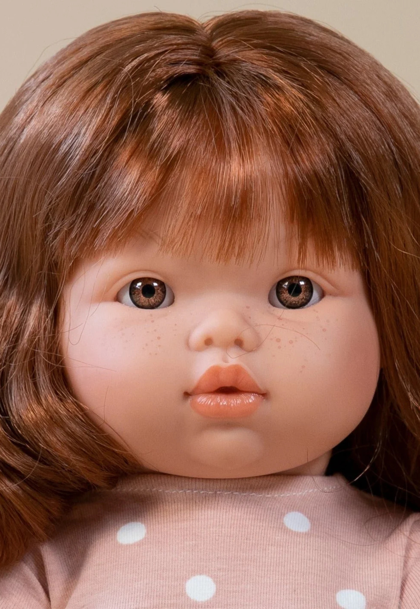 close up of mini coletos sophia doll showing hair and freckles