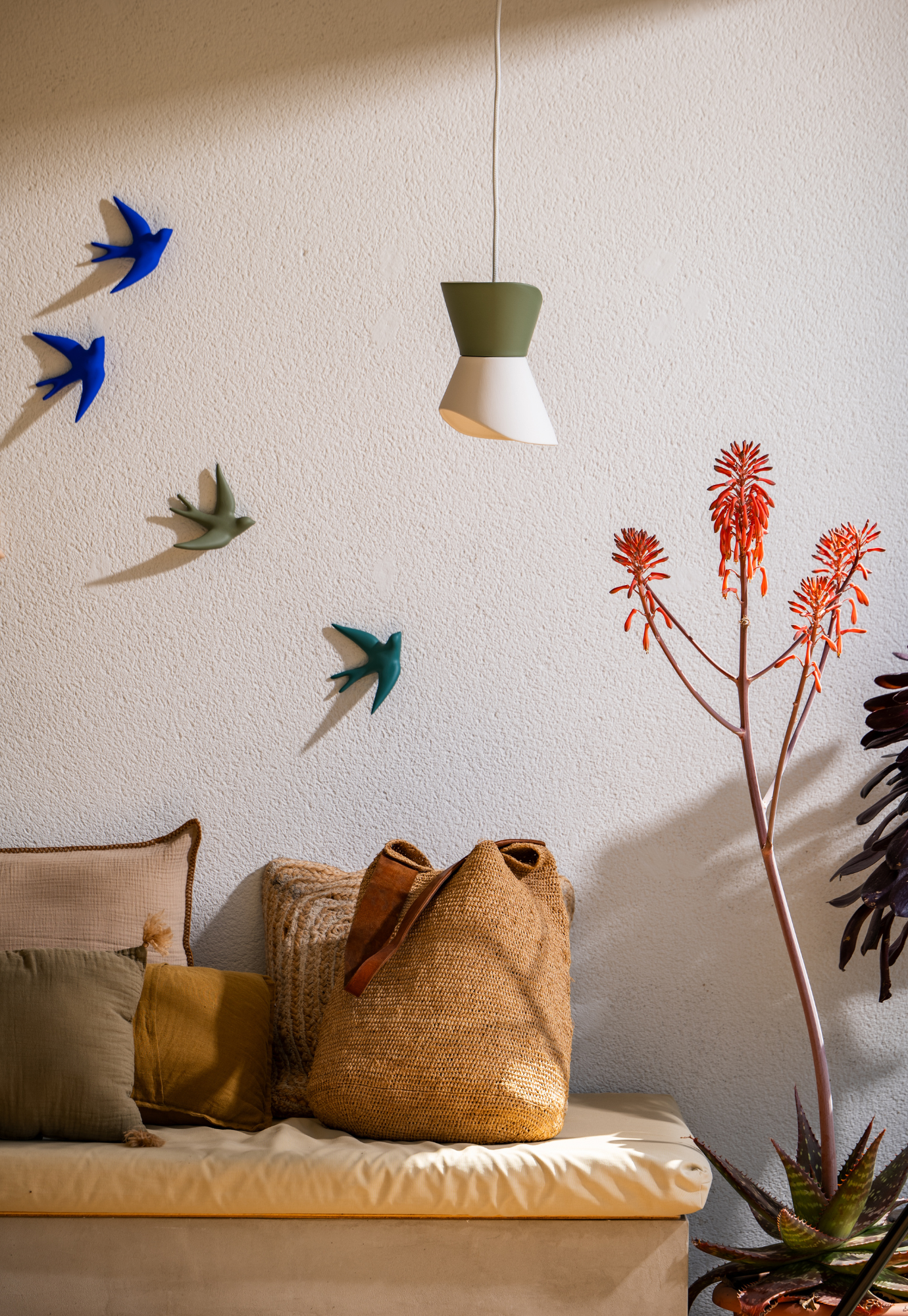 swallow wall décor bleu outremer hanging on wall in minimalist white room creating bold contrast