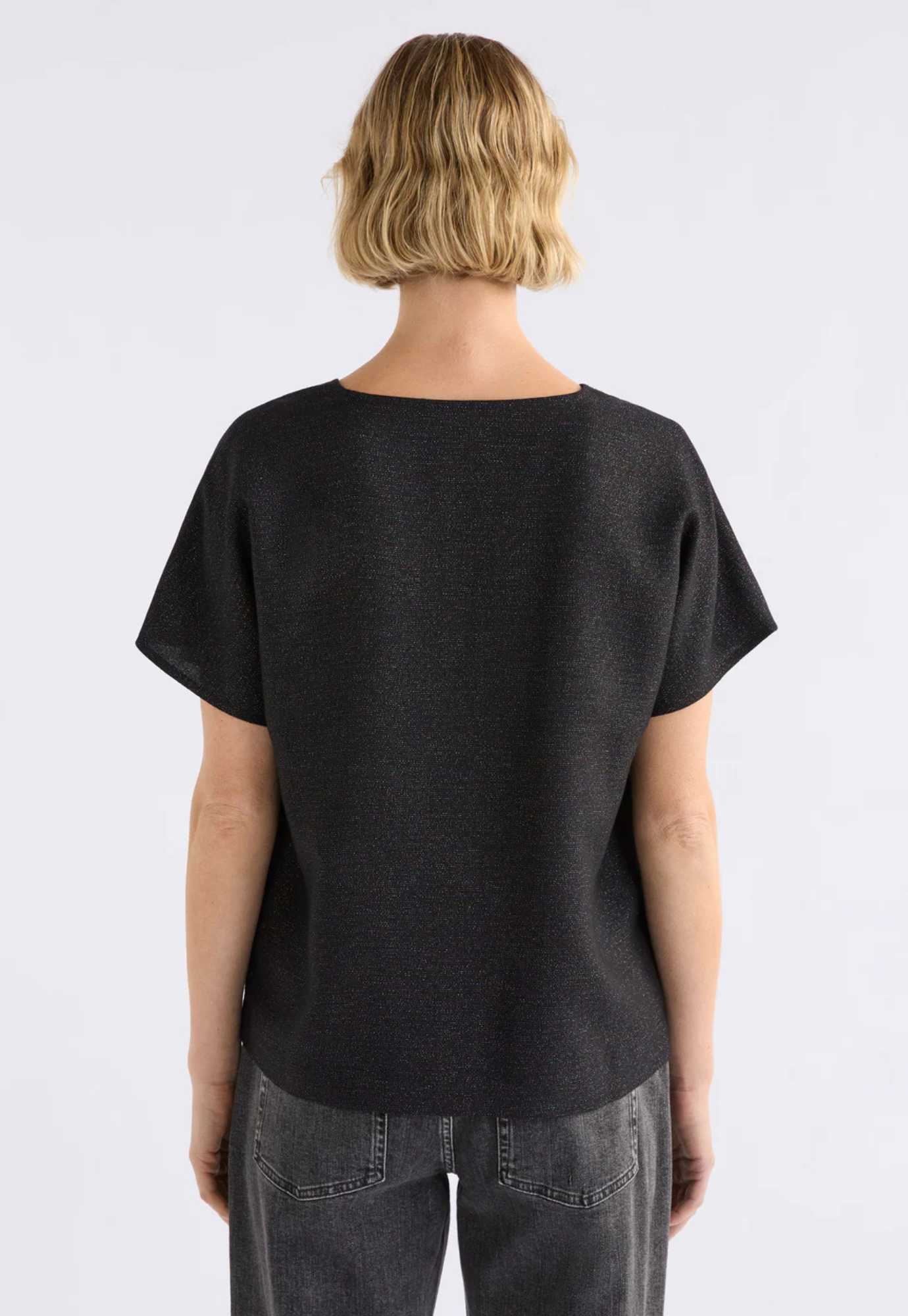 back view of the elk tulle top featuring small side splits and shimmer finish