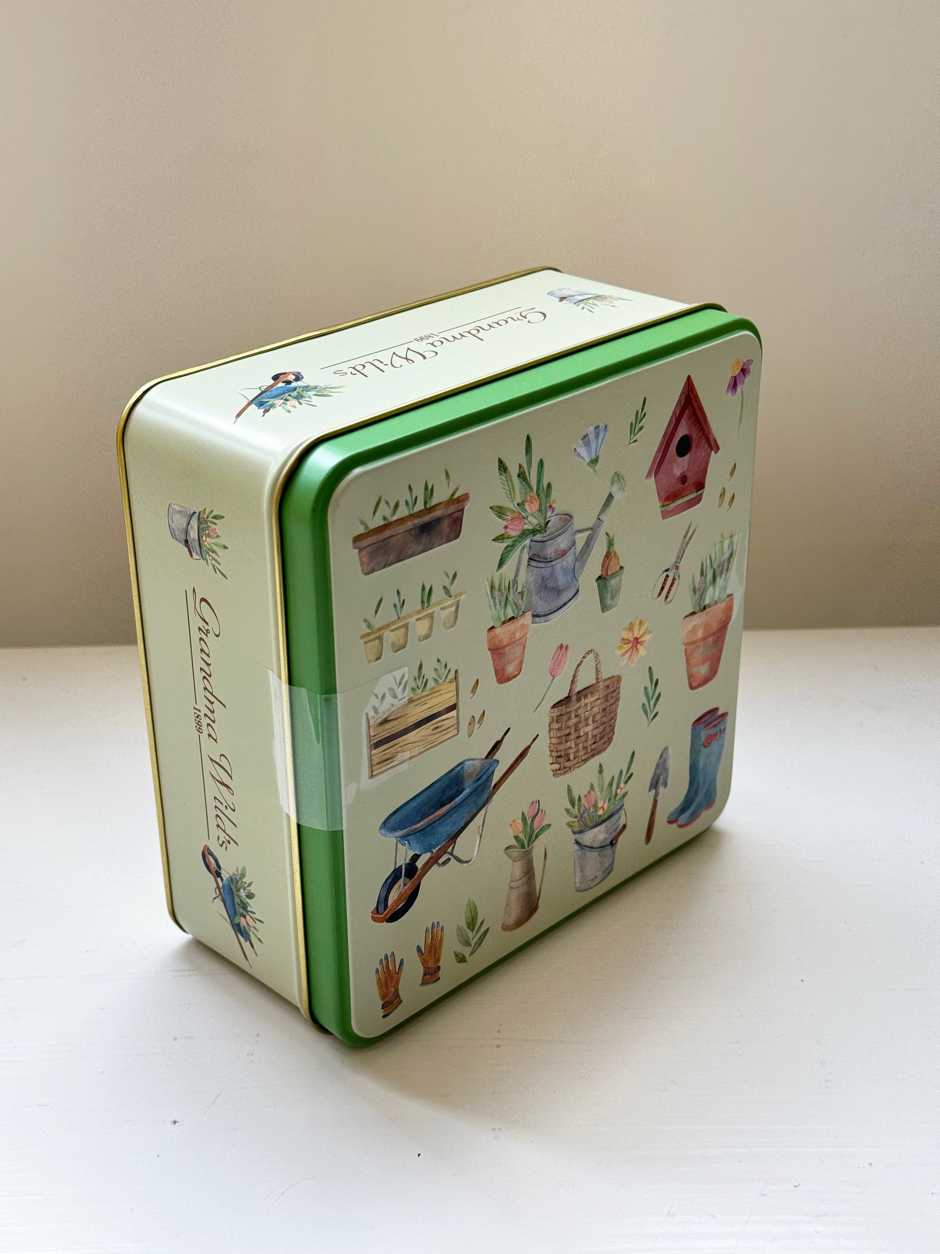 pottering garden embossed biscuit tin