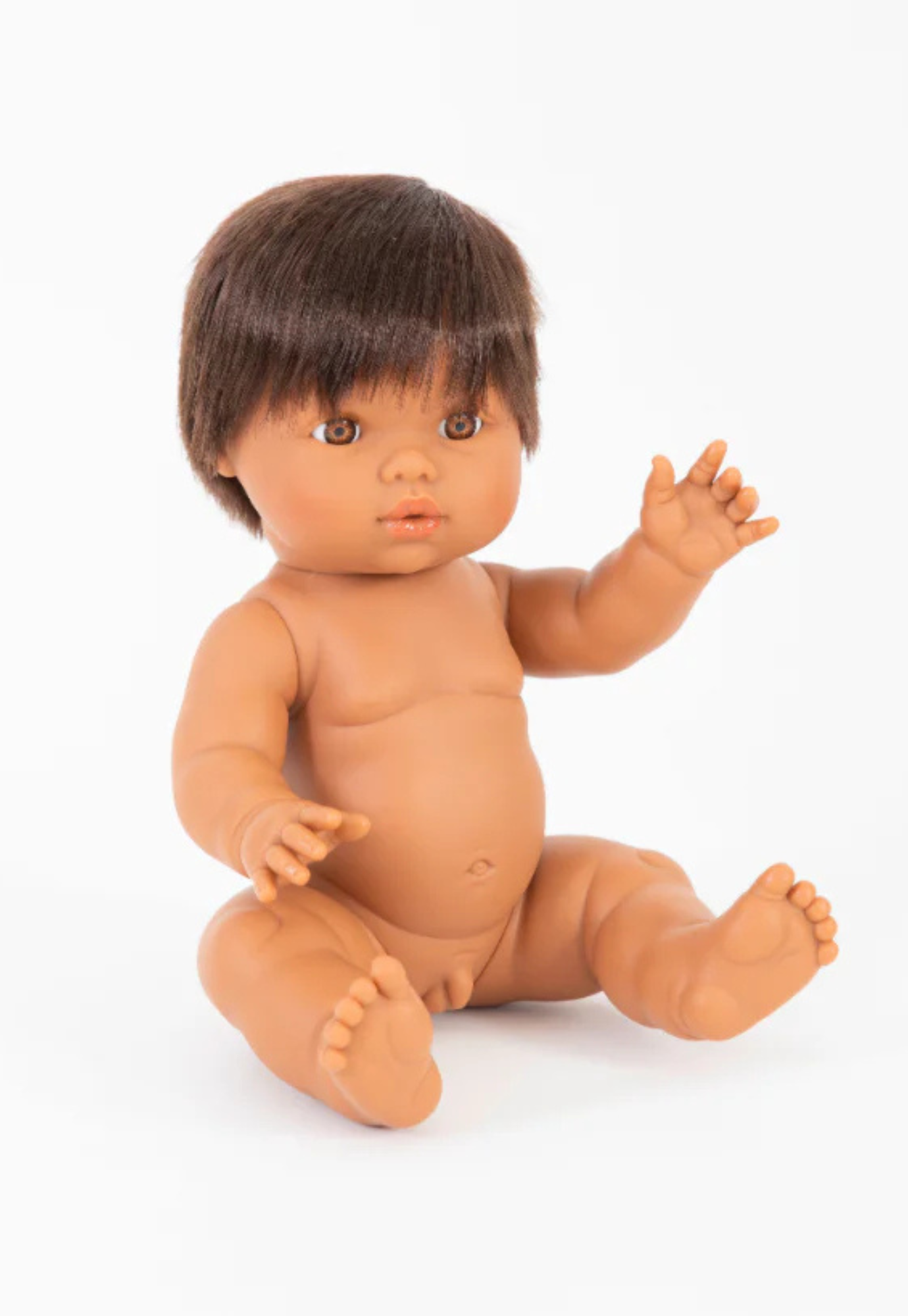 close up of mini coletos luka doll showing lifelike brown eyes dark brown hair and phthalate-free vinyl skin