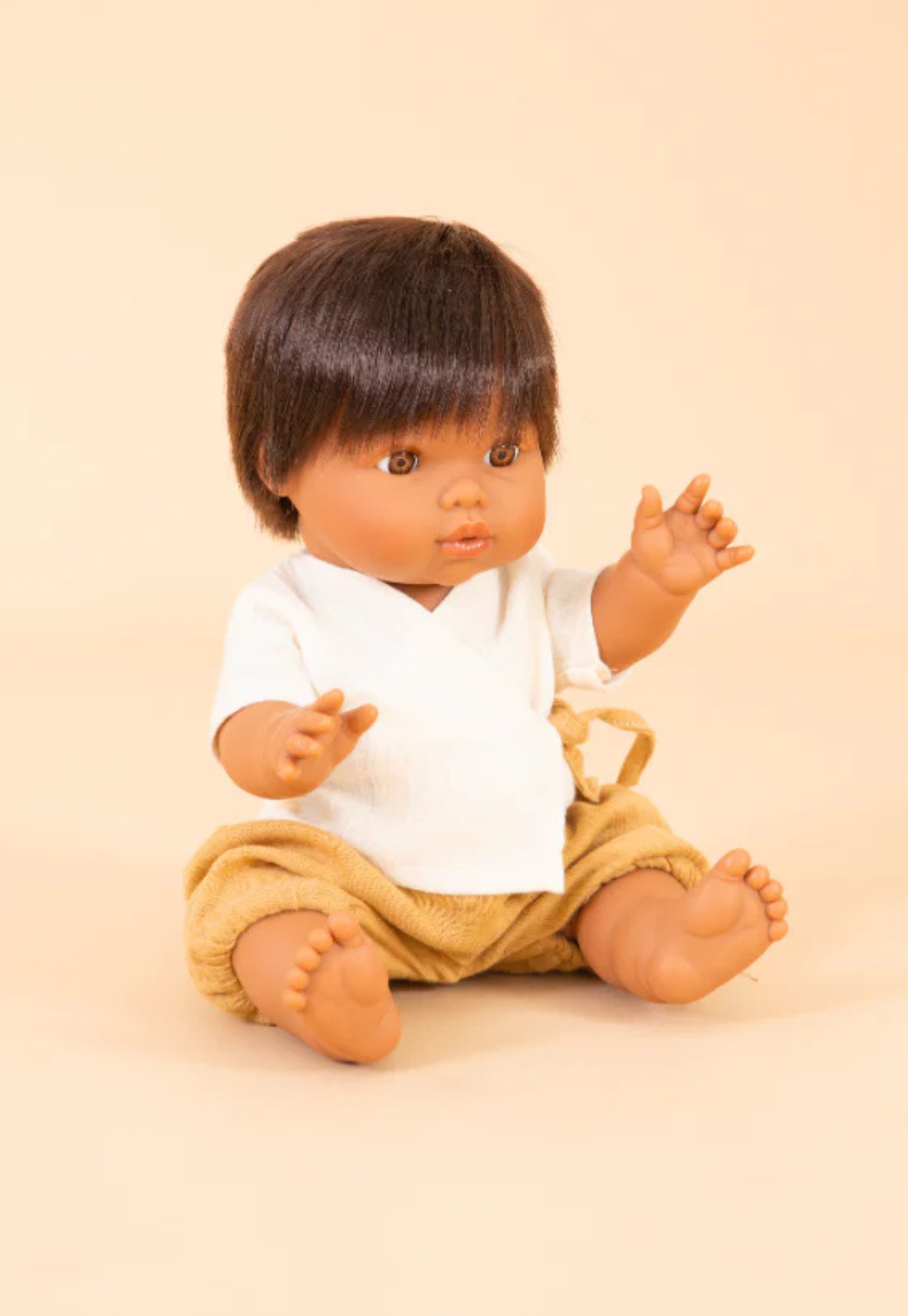 mini coletos luka doll seated on a chair showing movable limbs and child-friendly size